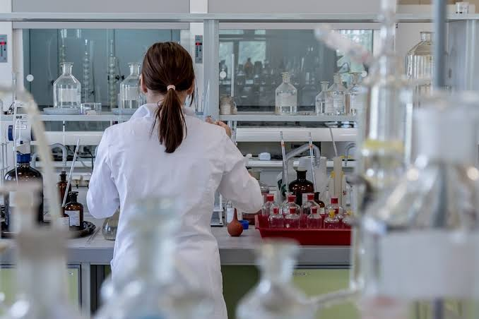 A researcher handling test tubes in a lab